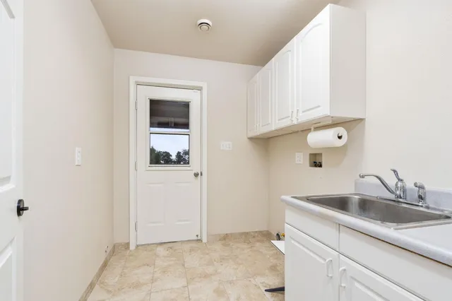 an empty room with windows and ceiling fan