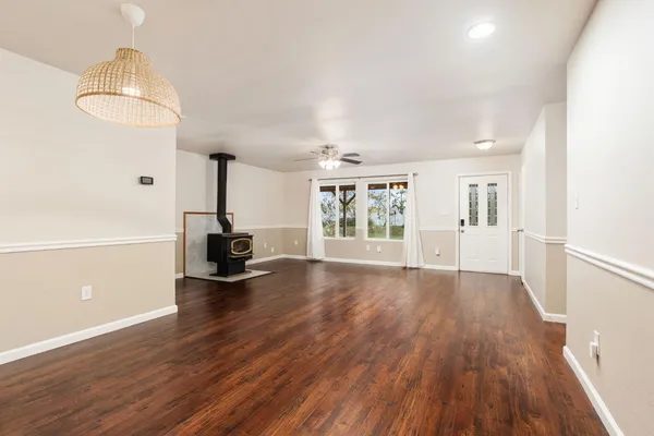 a kitchen with granite countertop wooden cabinets and a stove top oven