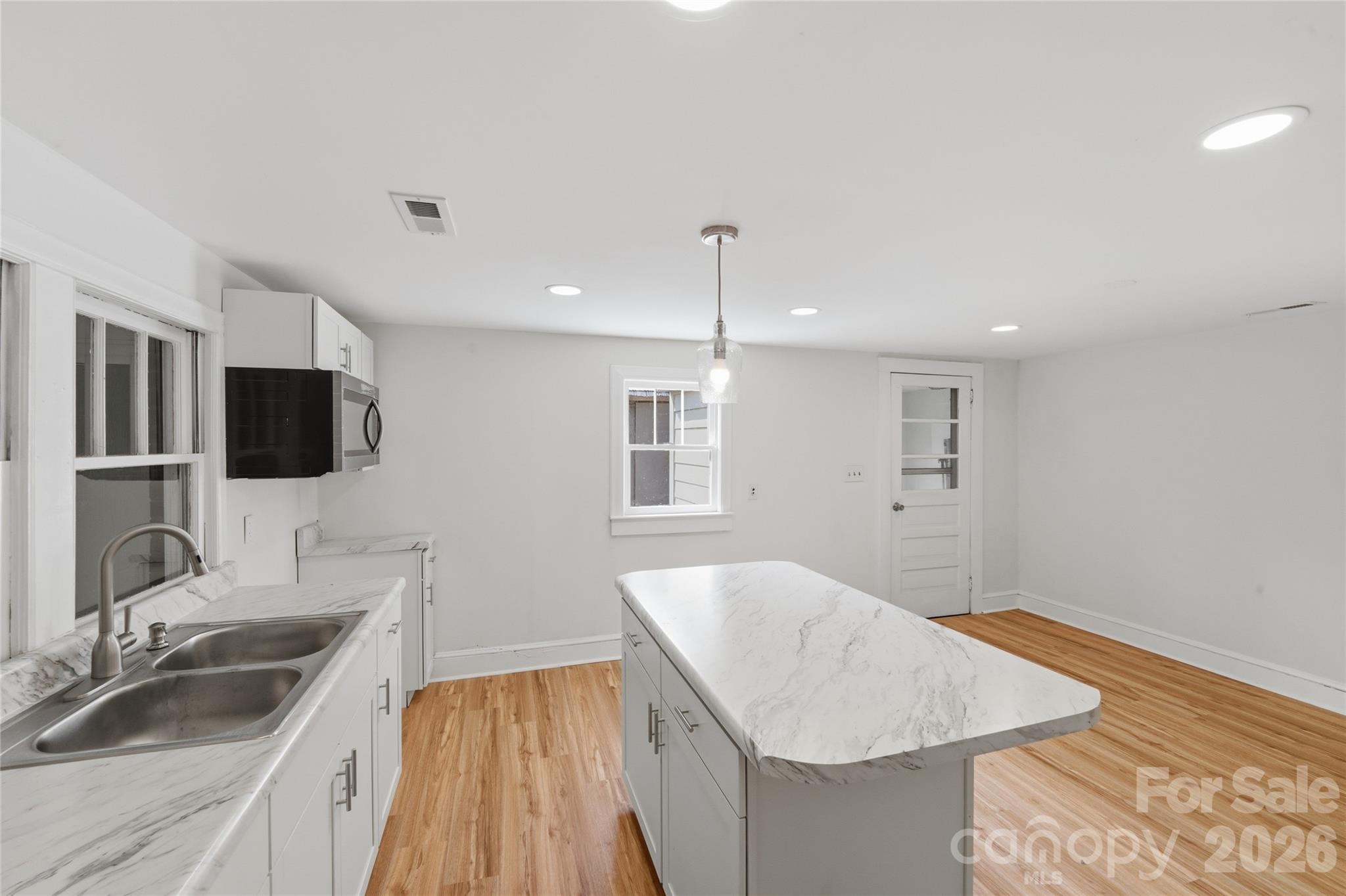 2231 Claremont Road Newton, NC 28658 - Photo 17 of 39 a kitchen with a sink and a refrigerator