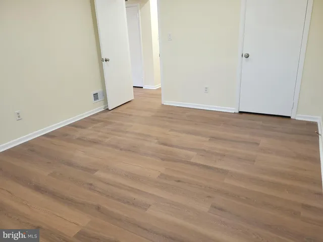 an empty room with wooden floor