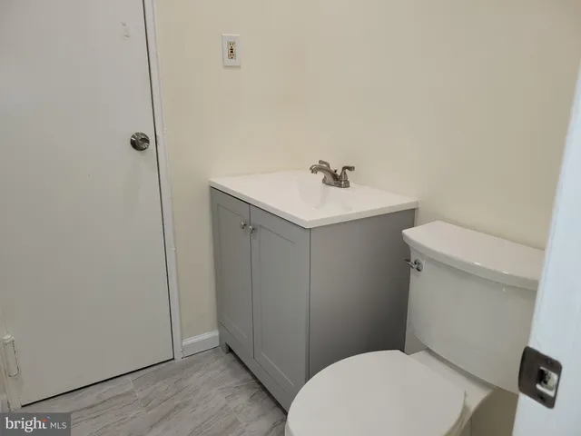 a white toilet sitting next to a bathroom sink