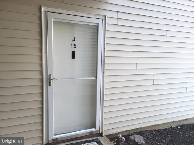 a view of a house with a wooden bench