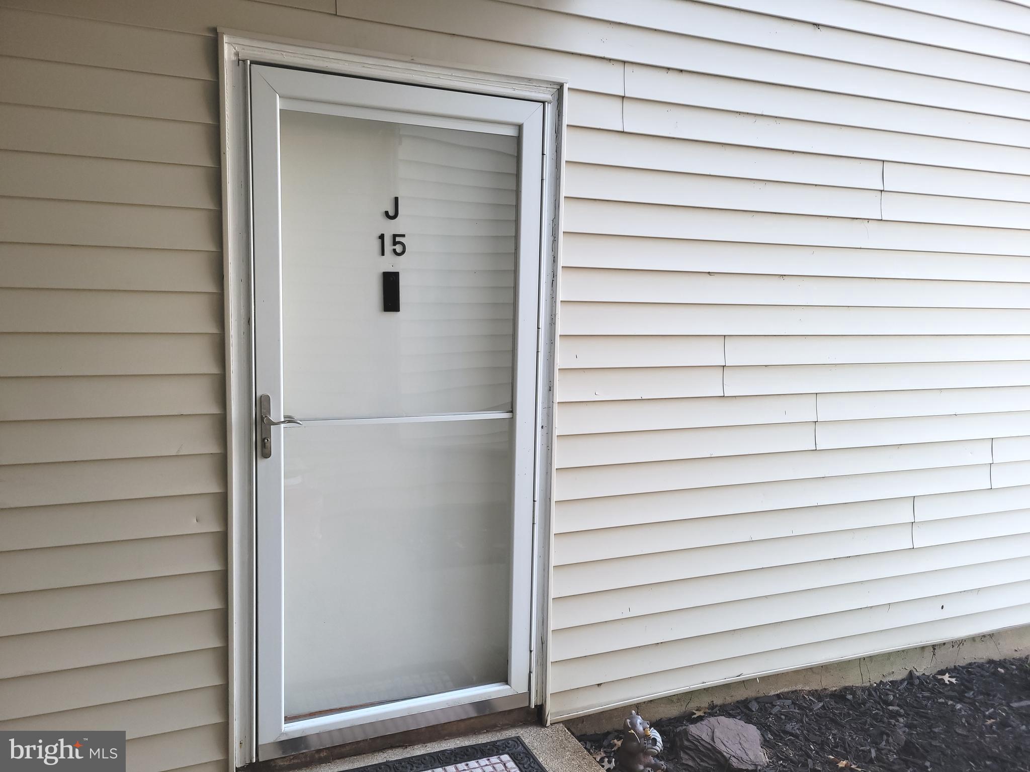 Avon Drive, Unit J East Windsor, NJ 08520 - Photo 3 of 15 a view of a house with a wooden bench