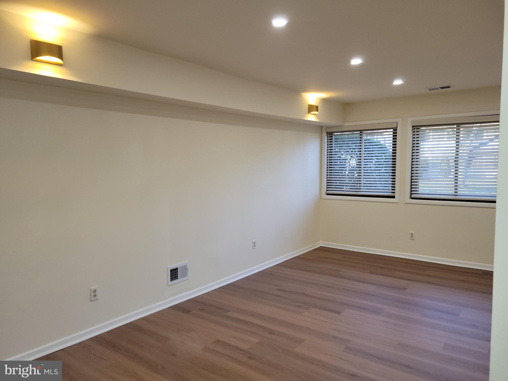 Avon Drive, Unit J East Windsor, NJ 08520 - Photo 6 of 15 an empty room with wooden floor and windows