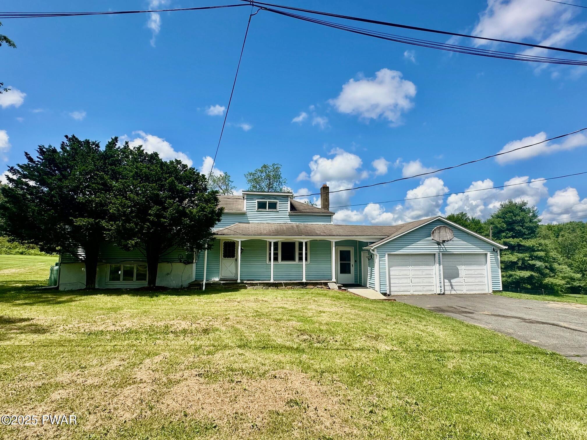 191 Hemlock Grove Road Greentown, PA 18426 - Photo 1 of 31 a front view of house with yard and green space