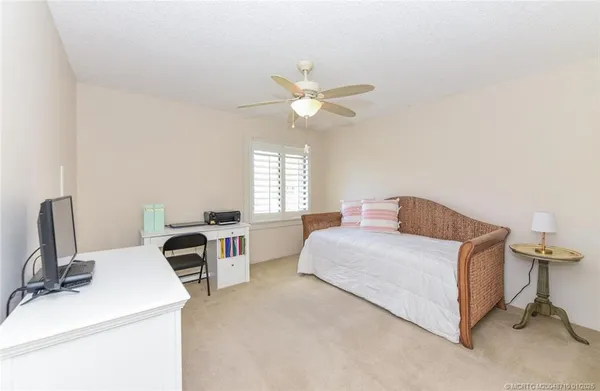 a bathroom with a granite countertop sink a toilet and a shower
