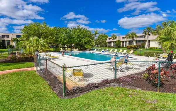 a green field with lots of trees