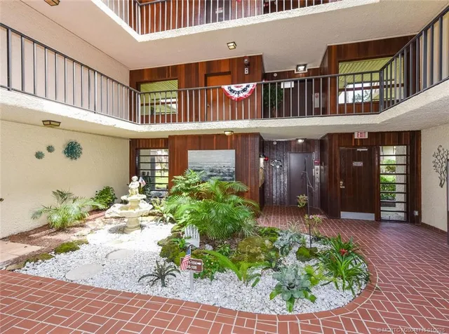 a front view of a house with a yard and outdoor seating