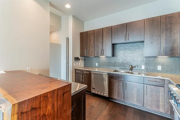 a kitchen with a sink stove and refrigerator