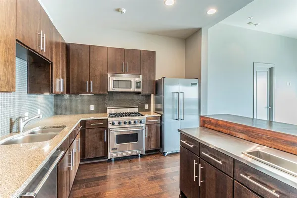 a view of a room with wooden floor and a window