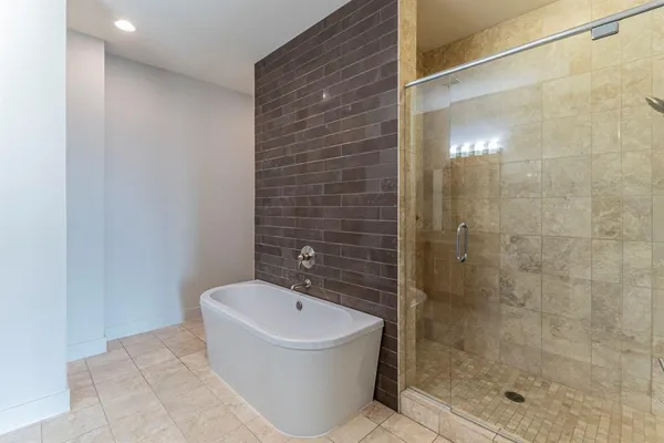 a view of an empty room with wooden floor and windows