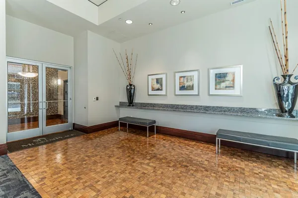a view of a room with wooden floor and windows