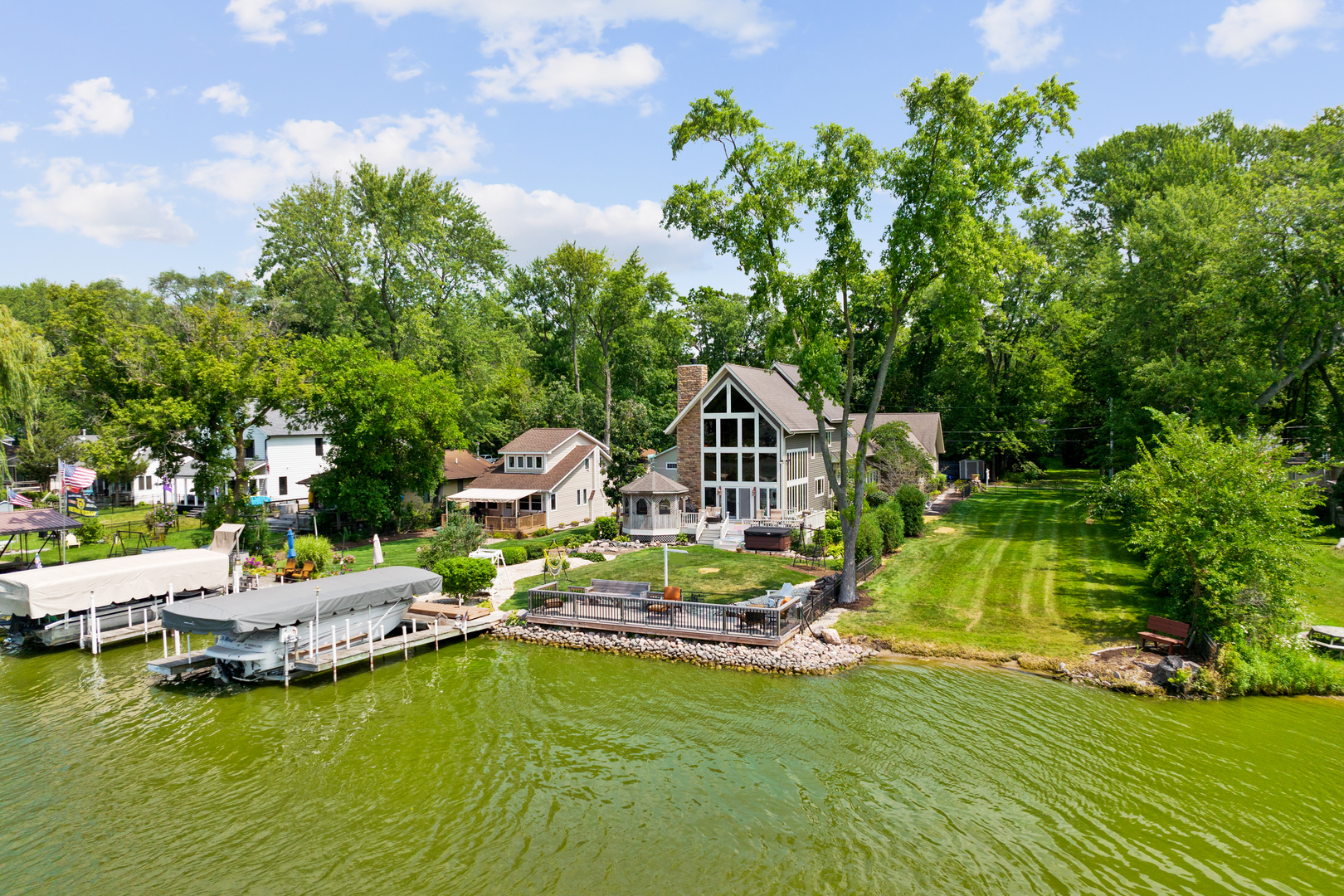 a aerial view of a house with swimming pool patio and lake view