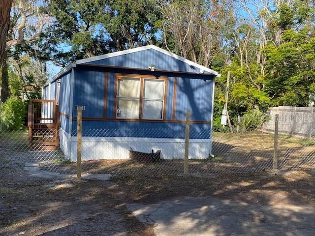 8631 Padget Street Hudson, FL 34667 - Photo 2 of 10 a small barn with a table and chairs under an umbrella