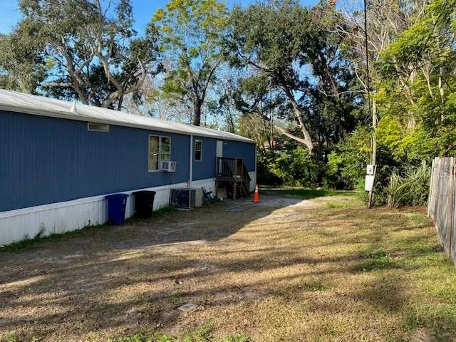 a view of a backyard with large trees