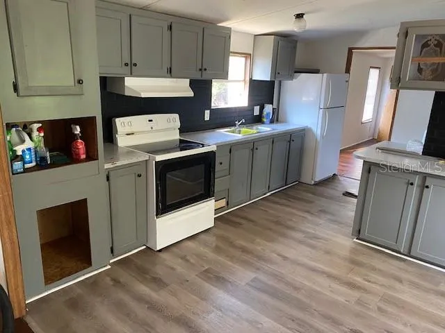 a kitchen with stainless steel appliances a stove a sink and a refrigerator