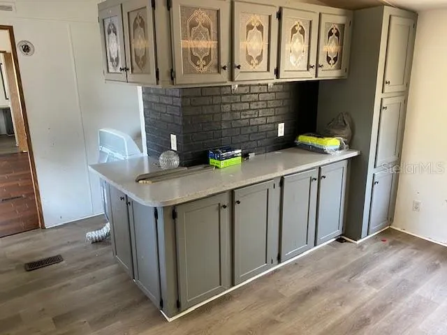 a kitchen with stainless steel appliances a sink and cabinets