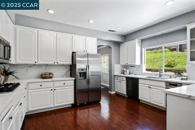 a kitchen with a sink and large window