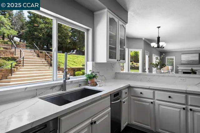 a kitchen with stainless steel appliances granite countertop a stove microwave and cabinets