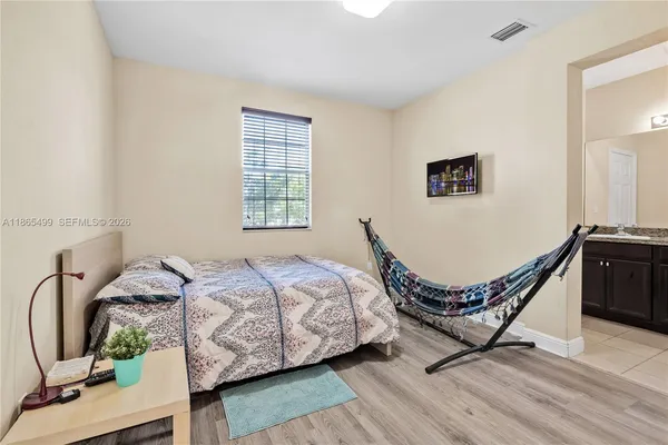 a bedroom with a bed chair and a window