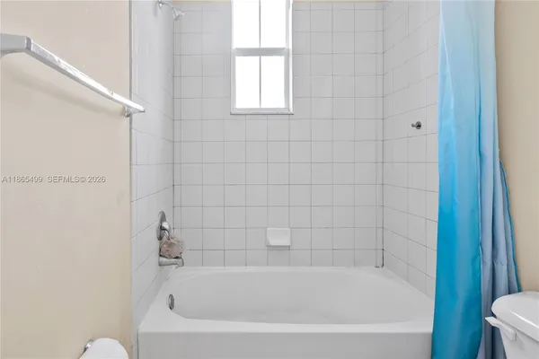 a white bath tub sitting next to a window
