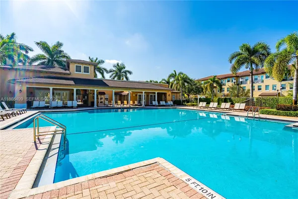 a view of house with swimming pool yard and outdoor seating