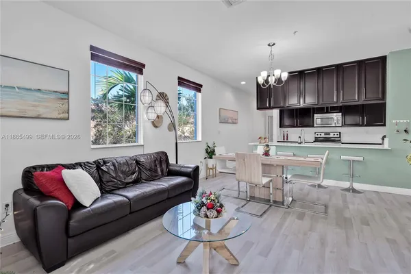 a living room with furniture kitchen and a view of kitchen