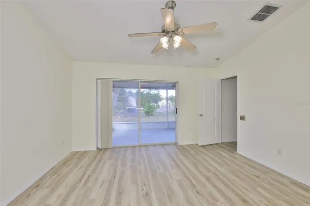 wooden floor in an empty room with a mirror