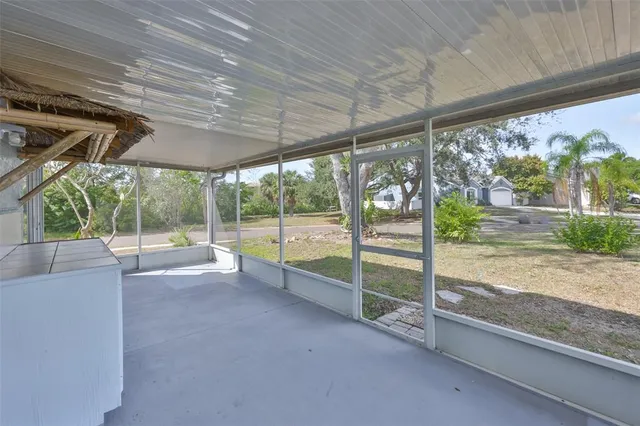 a view of empty room with wooden floor and floor to ceiling window
