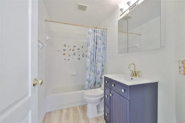 a bathroom with a sink toilet tub and shower