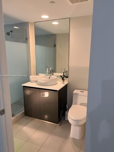 31 Southeast 6th Street, Unit 1606 Miami, FL 33131 - Photo 12 of 27 a bathroom with a sink vanity and a toilet