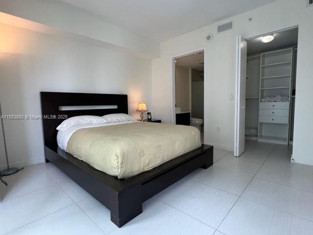 31 Southeast 6th Street, Unit 1606 Miami, FL 33131 - Photo 13 of 27 a bed sitting in a bedroom and table