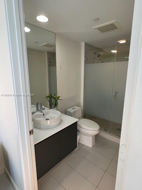 31 Southeast 6th Street, Unit 1606 Miami, FL 33131 - Photo 14 of 27 a bathroom with a sink a toilet and shower