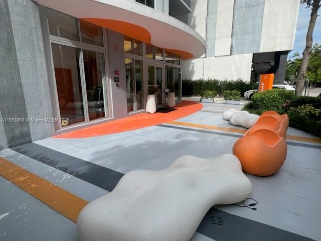 31 Southeast 6th Street, Unit 1606 Miami, FL 33131 - Photo 2 of 27 an outdoor space with pool and furniture