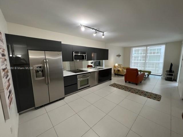 31 Southeast 6th Street, Unit 1606 Miami, FL 33131 - Photo 5 of 27 a kitchen with stainless steel appliances granite countertop a refrigerator and a stove top oven
