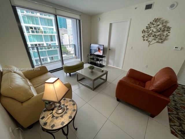 31 Southeast 6th Street, Unit 1606 Miami, FL 33131 - Photo 7 of 27 a living room with furniture and a large window
