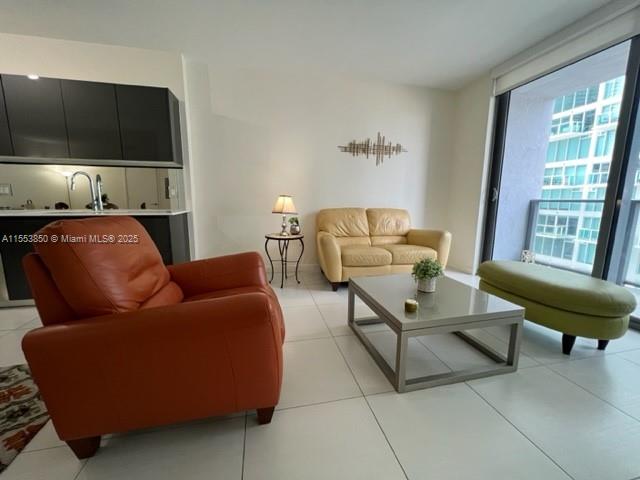 31 Southeast 6th Street, Unit 1606 Miami, FL 33131 - Photo 8 of 27 a living room with furniture and a flat screen tv