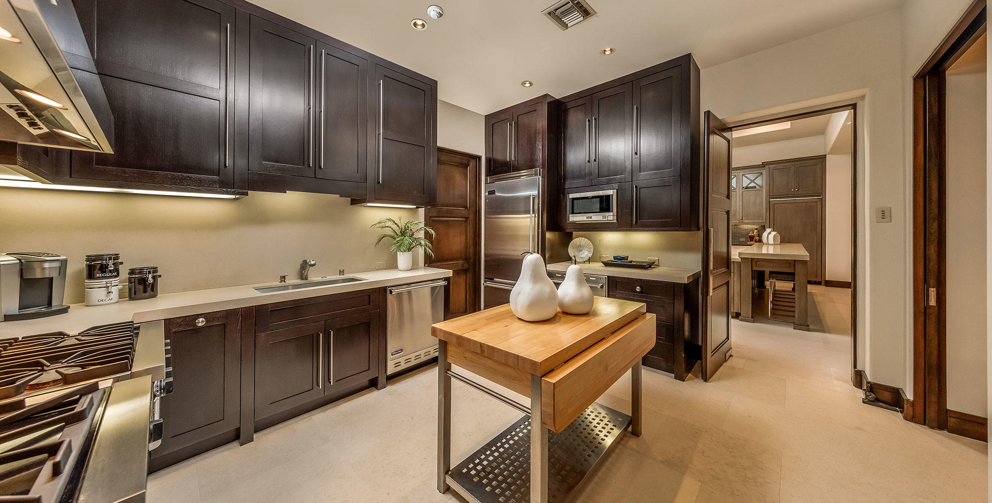 1011 Mountain Spring Palm Desert, CA 92260 - Photo 5 of 16 a kitchen with cabinets and chairs