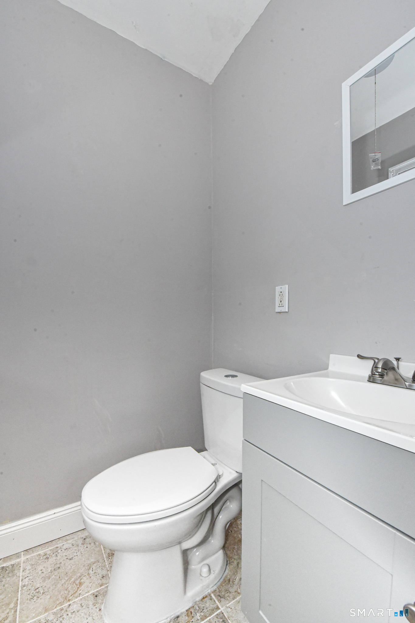 63 Park Road Hamden, CT 06517 - Photo 14 of 39 a bathroom with a sink a toilet and a mirror