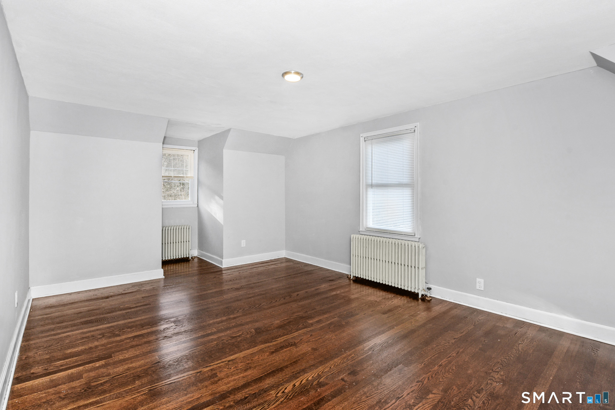 63 Park Road Hamden, CT 06517 - Photo 19 of 39 an empty room with wooden floor and window