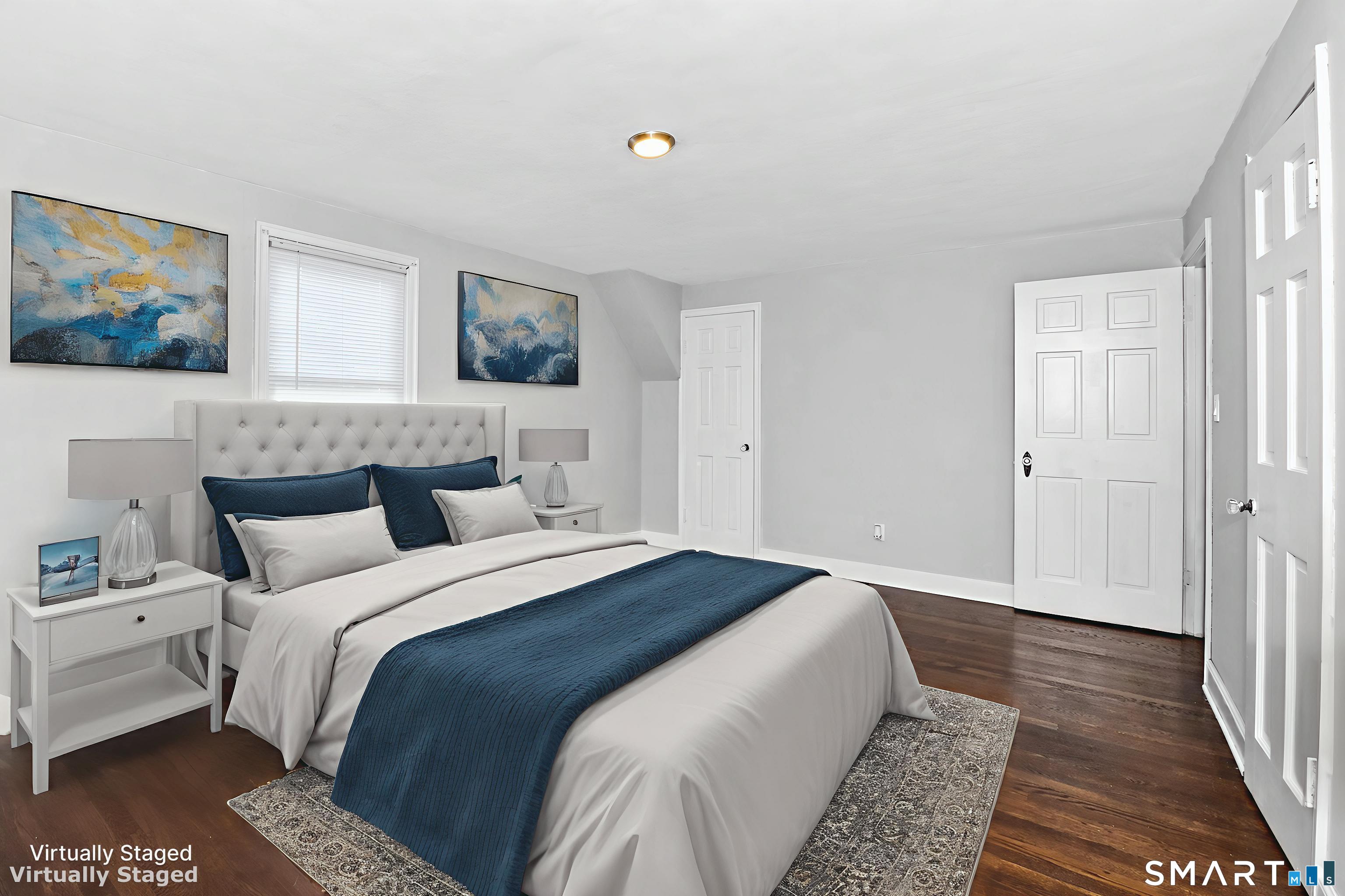 63 Park Road Hamden, CT 06517 - Photo 20 of 39 a bedroom with a bed and a painting on the wall