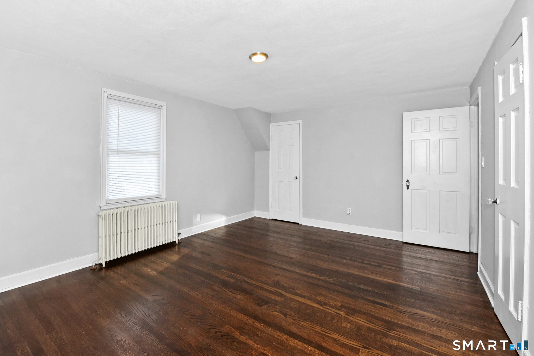 63 Park Road Hamden, CT 06517 - Photo 21 of 39 an empty room with wooden floor and window