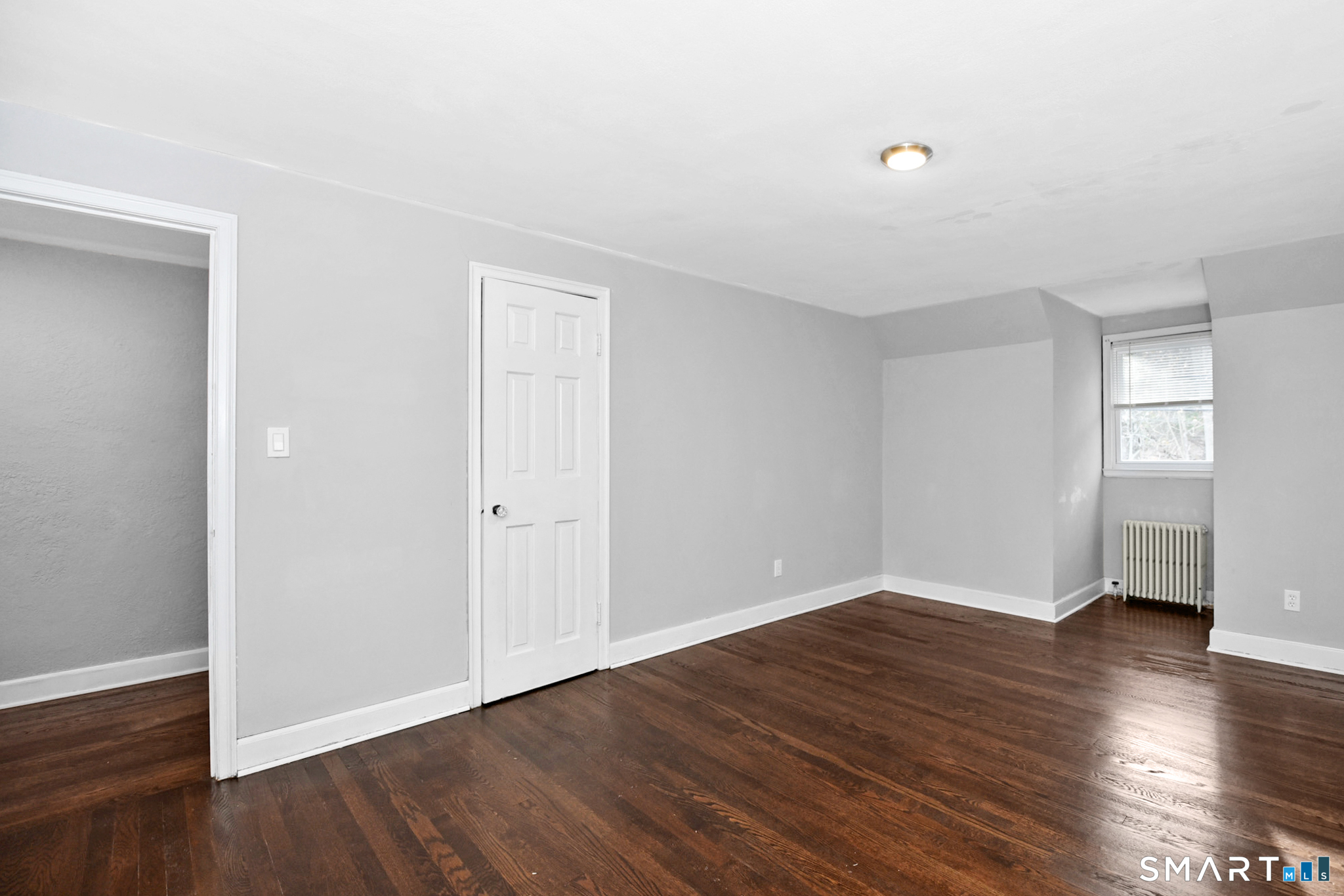 63 Park Road Hamden, CT 06517 - Photo 23 of 39 a view of an empty room with wooden floor and a window