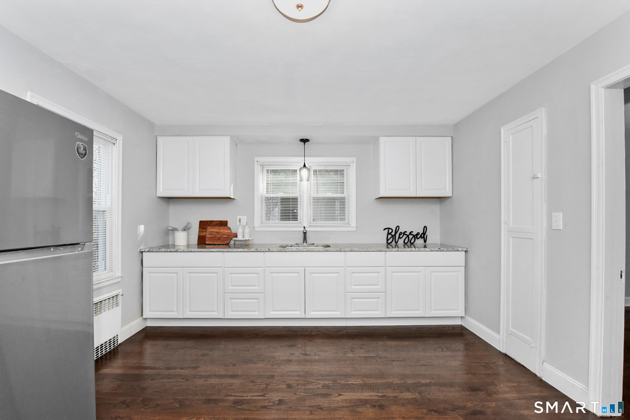 63 Park Road Hamden, CT 06517 - Photo 3 of 39 a kitchen with granite countertop a sink cabinets and stainless steel appliances