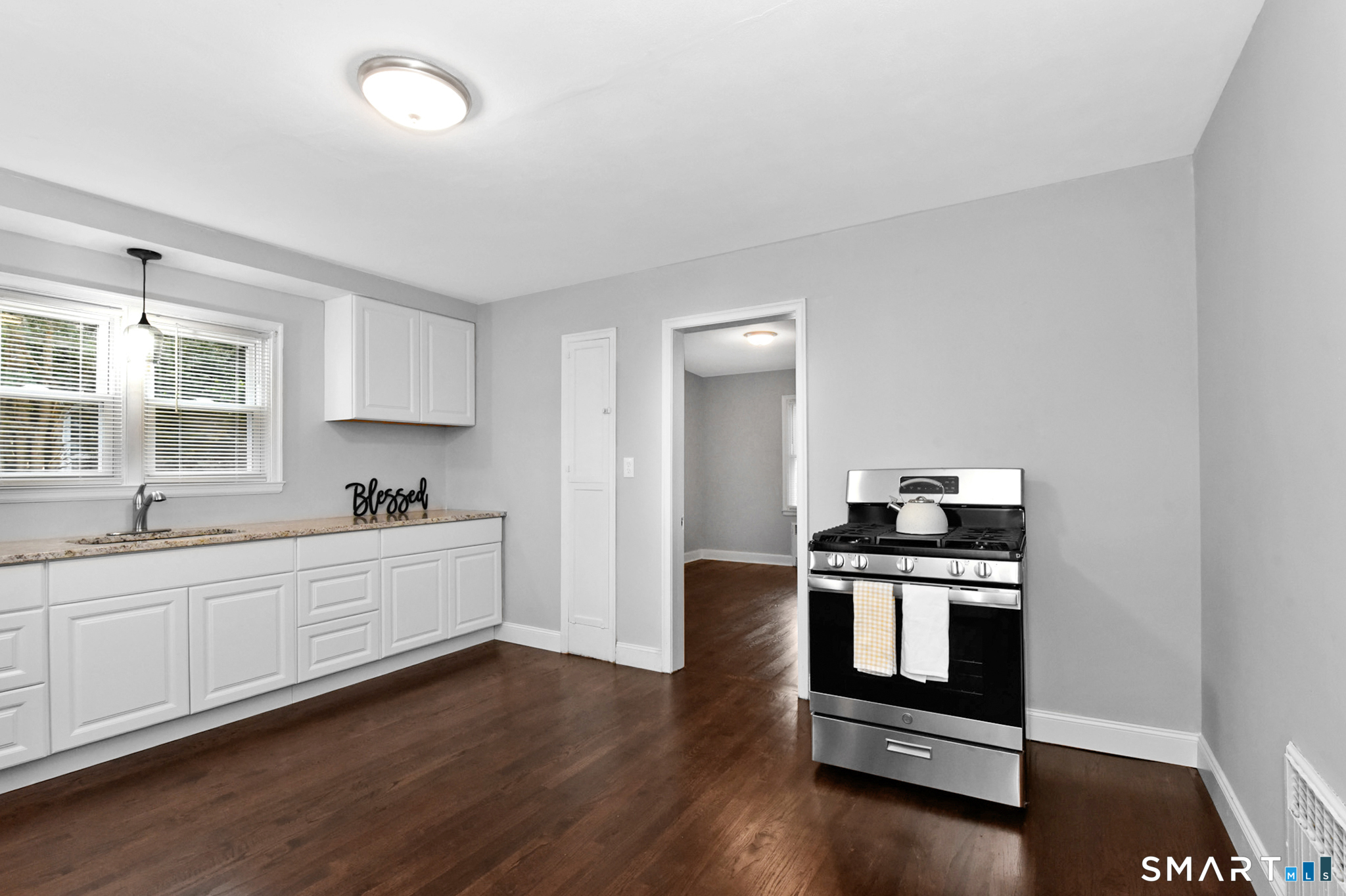 63 Park Road Hamden, CT 06517 - Photo 5 of 39 a kitchen with stainless steel appliances a stove a sink and white cabinets