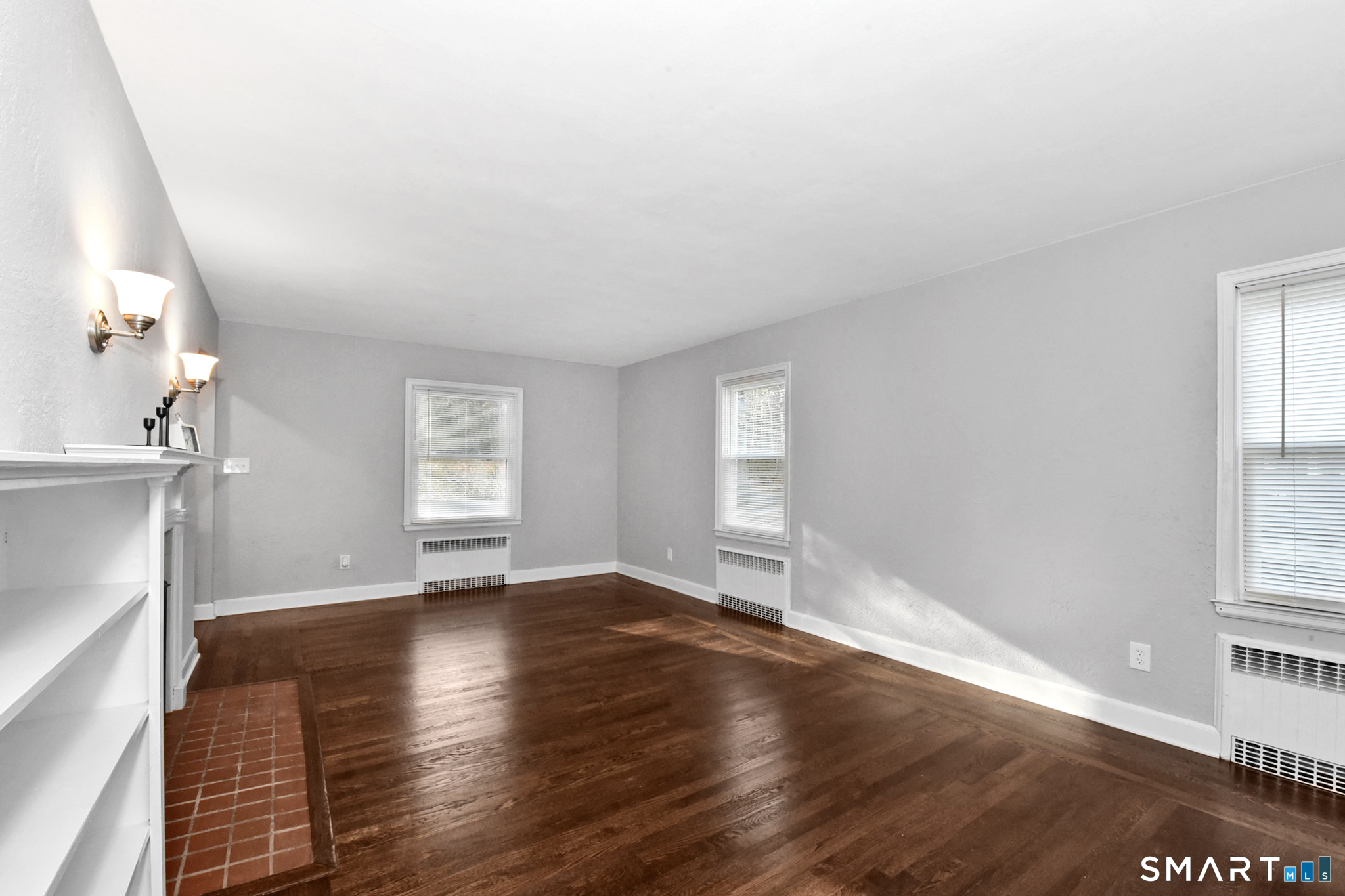 63 Park Road Hamden, CT 06517 - Photo 9 of 39 an empty room with wooden floor and windows