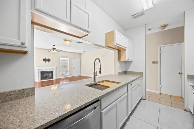 a kitchen with stainless steel appliances granite countertop a sink and a refrigerator