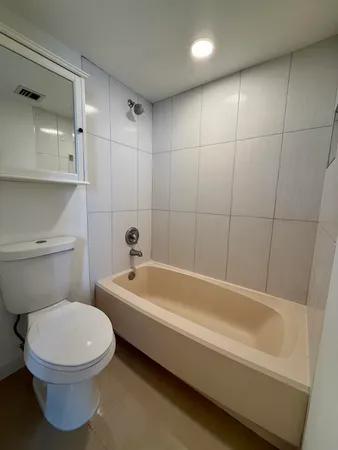 a bathroom with a toilet a sink and bathtub