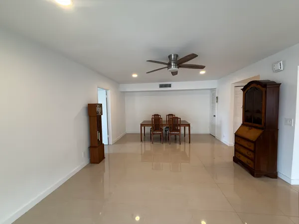a view of a livingroom with furniture and a ceiling fan