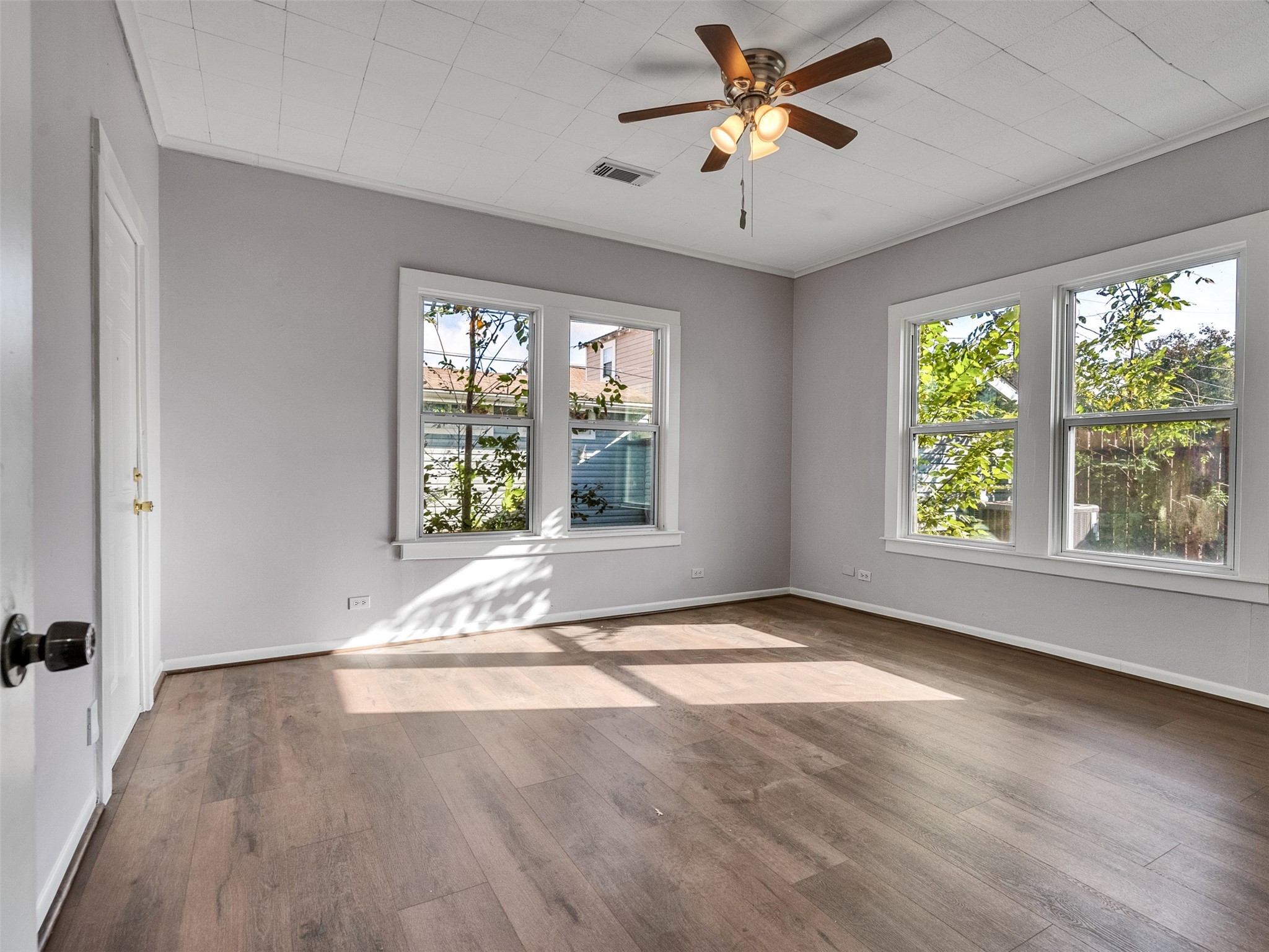 4625 Bell Street Houston, TX 77023 - Photo 14 of 33 a view of an empty room with a window and wooden floor